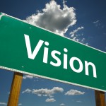 Vision Road Sign with dramatic blue sky and clouds.